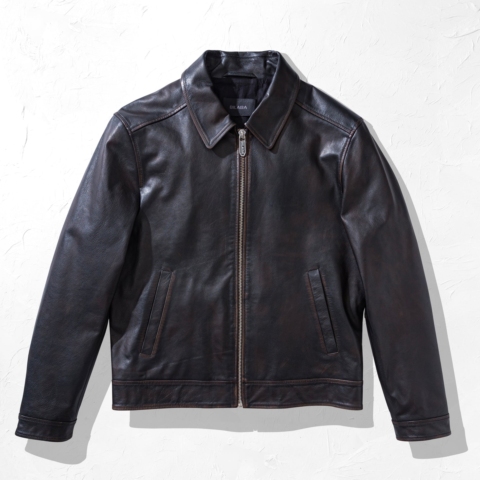 Black vintage leather jacket on a white background