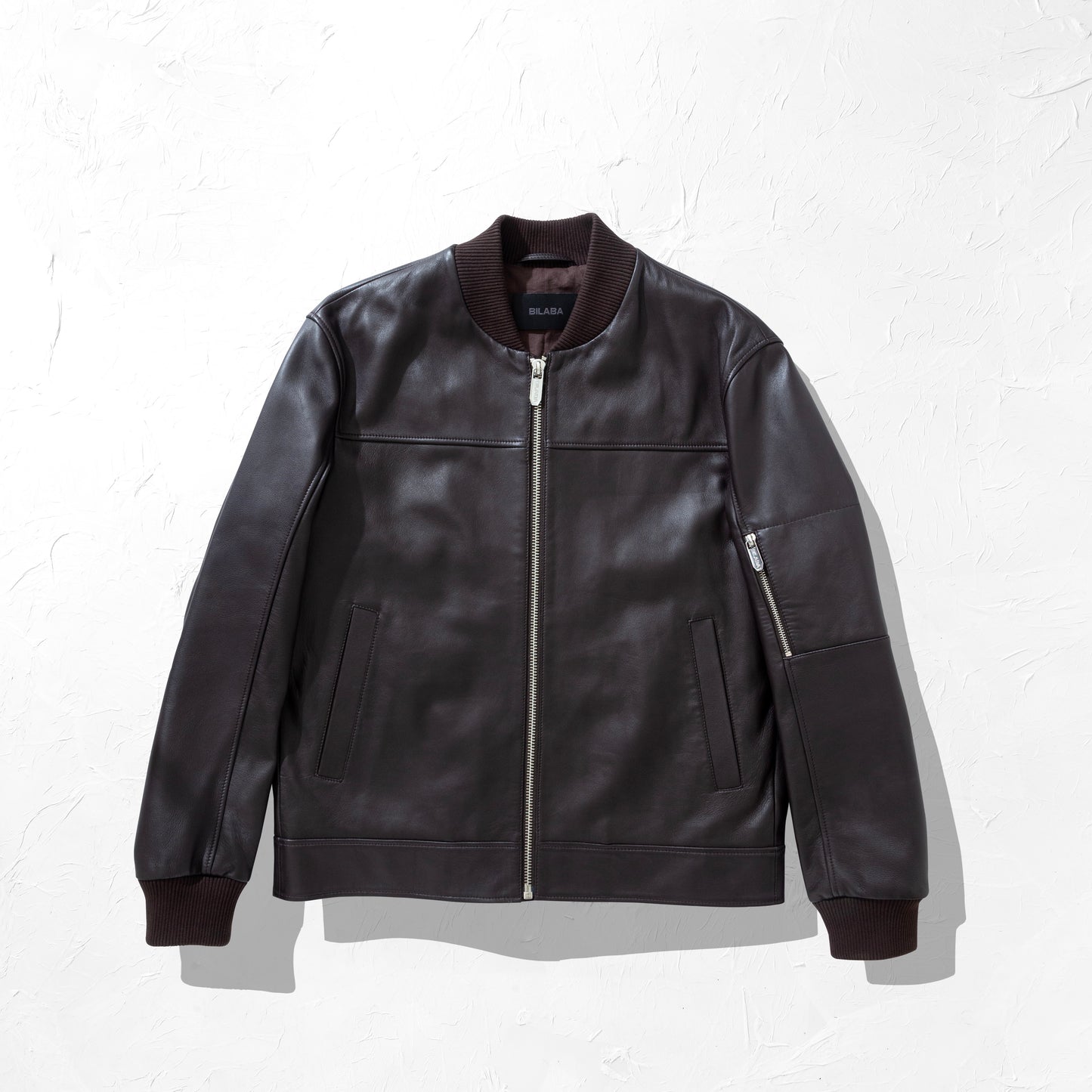 Brown Bomber leather jacket on a white background