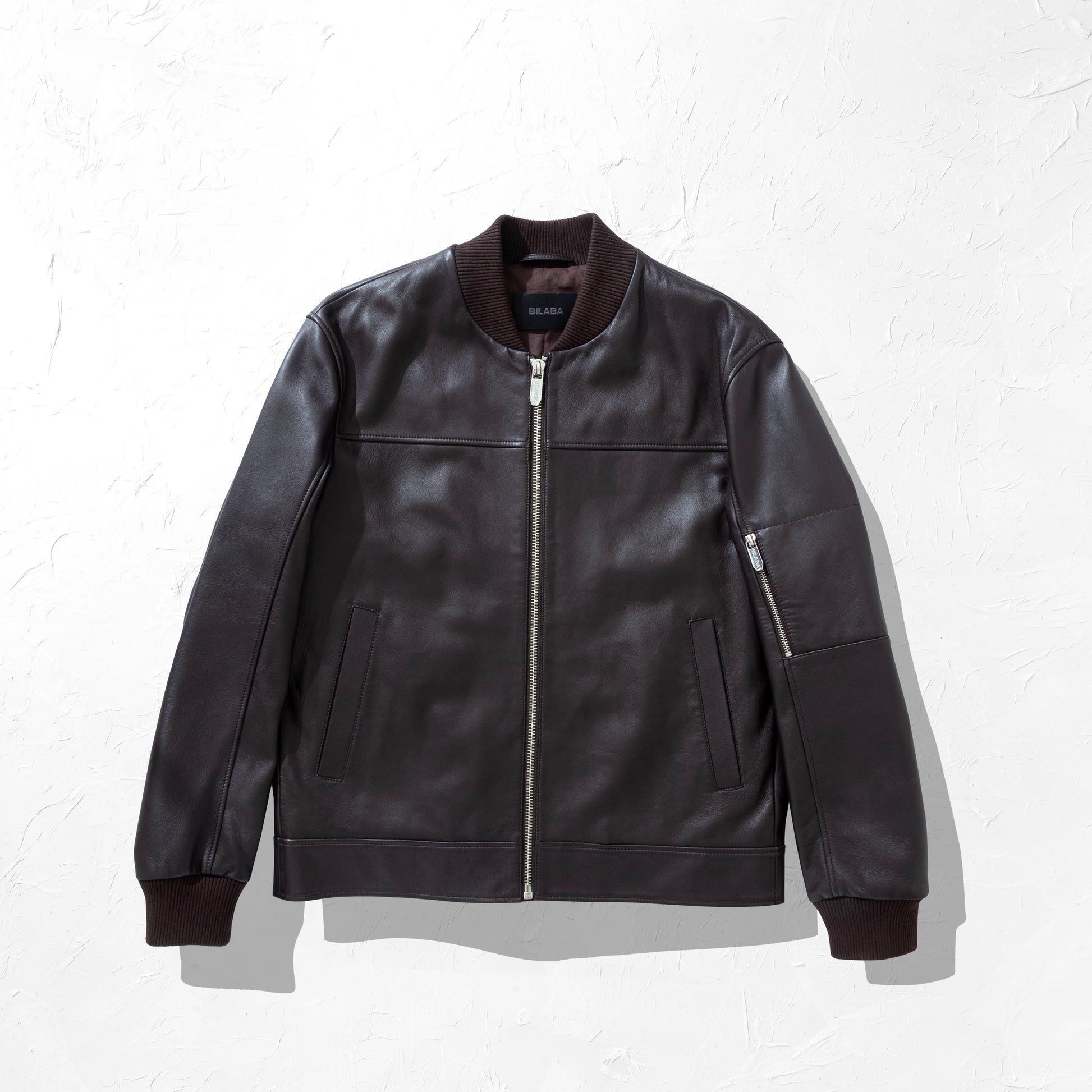 Brown Bomber leather jacket on a white background