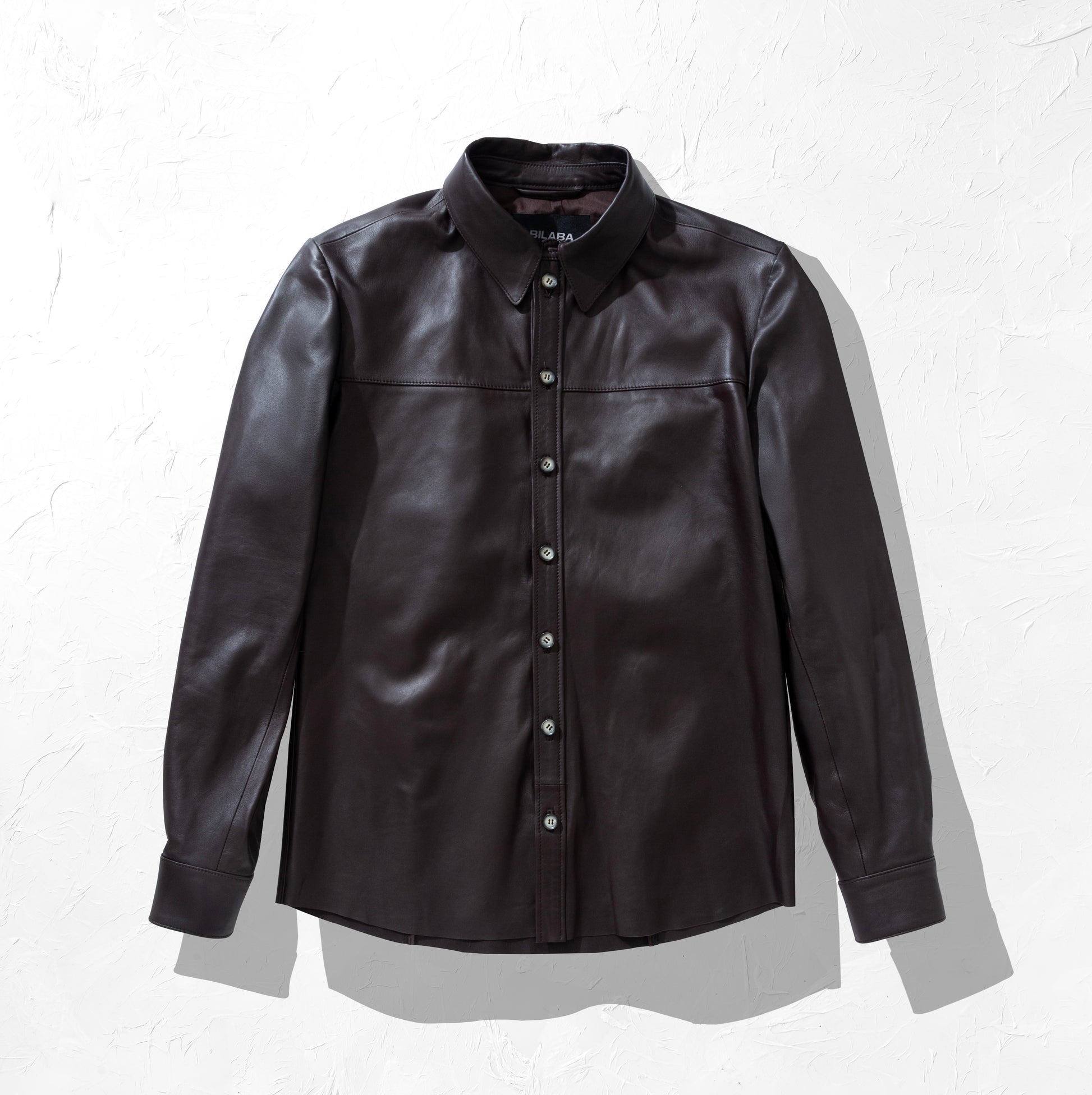Brown leather shirt on a white background