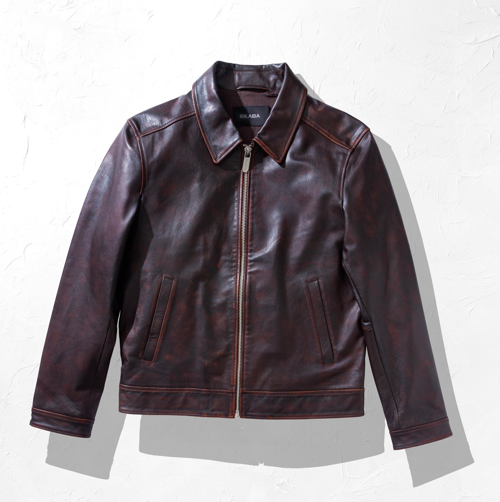 Brown leather jacket on a white background