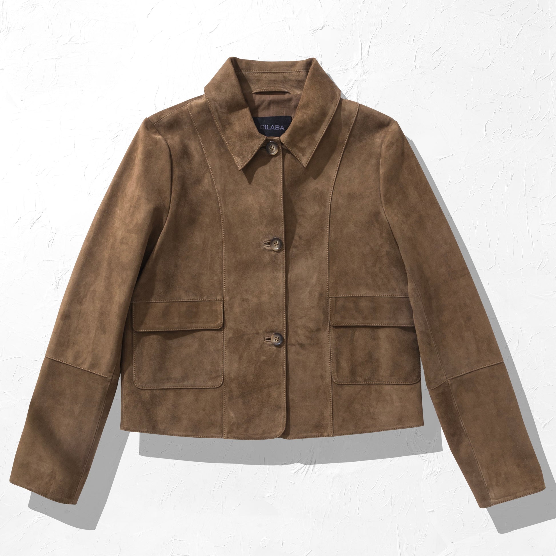 Brown suede jacket on a white background